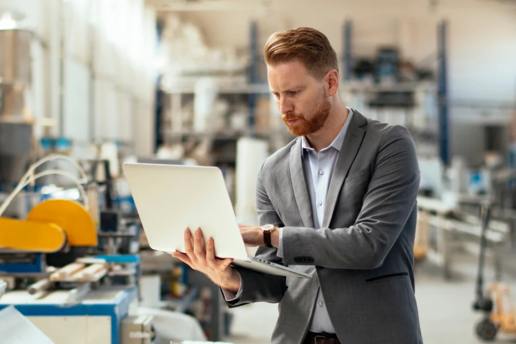 Manager reviewing production data in supplement manufacturing facility to verify track record