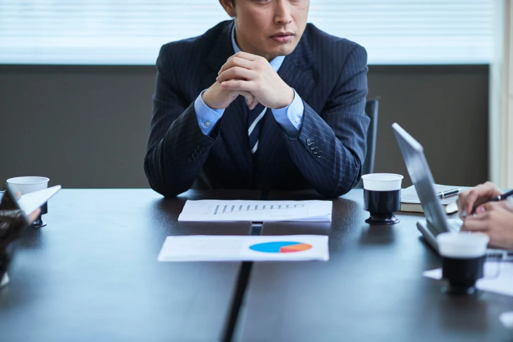 Business professionals reviewing charts and reports, evaluating manufacturer risk for a supplement brand.