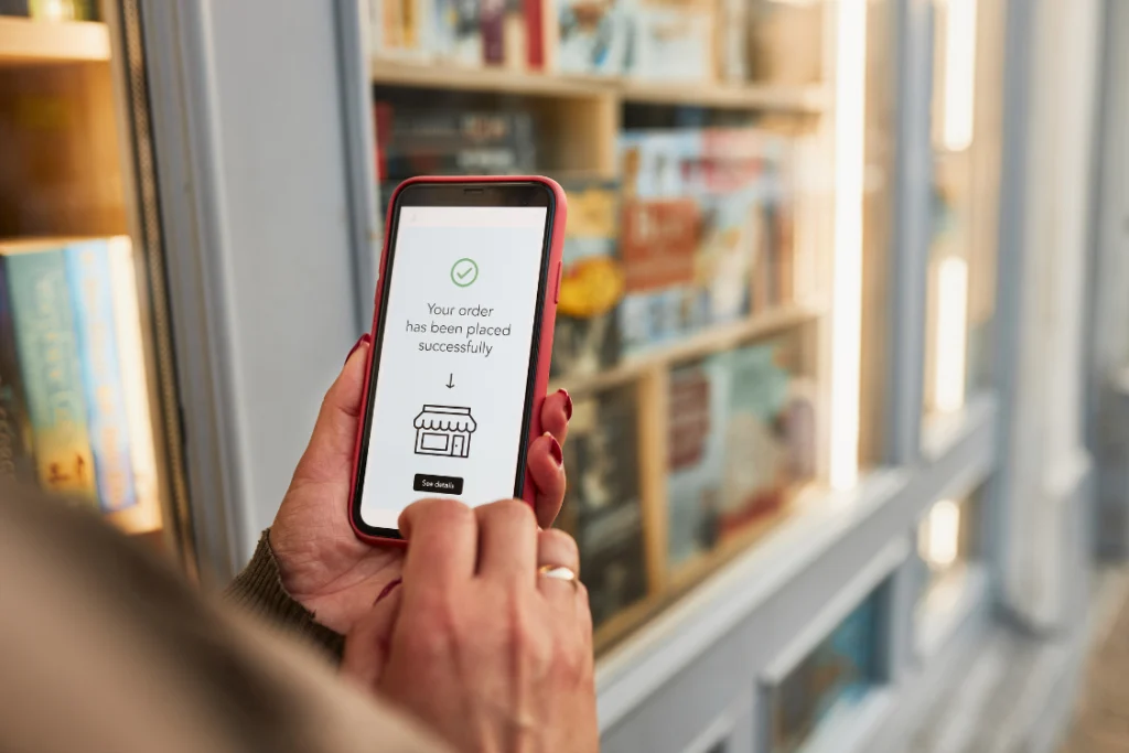 Close-up of a mobile phone showing an "Order successfully placed" screen, reflecting a successful transaction under staggered ordering supplements.